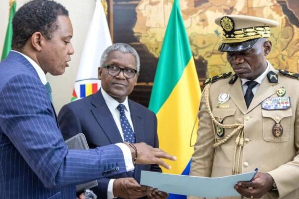 Dangote Group CEO (middle) during an audience with Gabon's transitional president (far right)